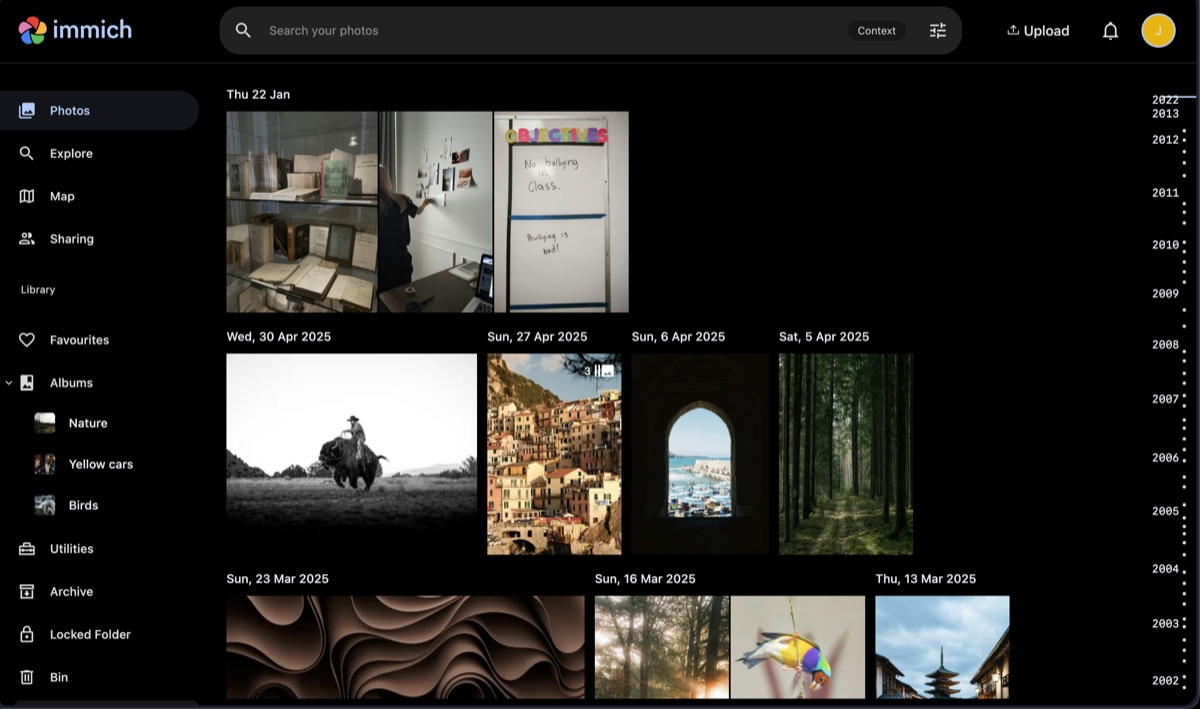 Immich photo timeline showing a self-hosted library with dated photo groups, albums, and search